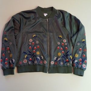 Green silky bomber jacket with floral embroidery.